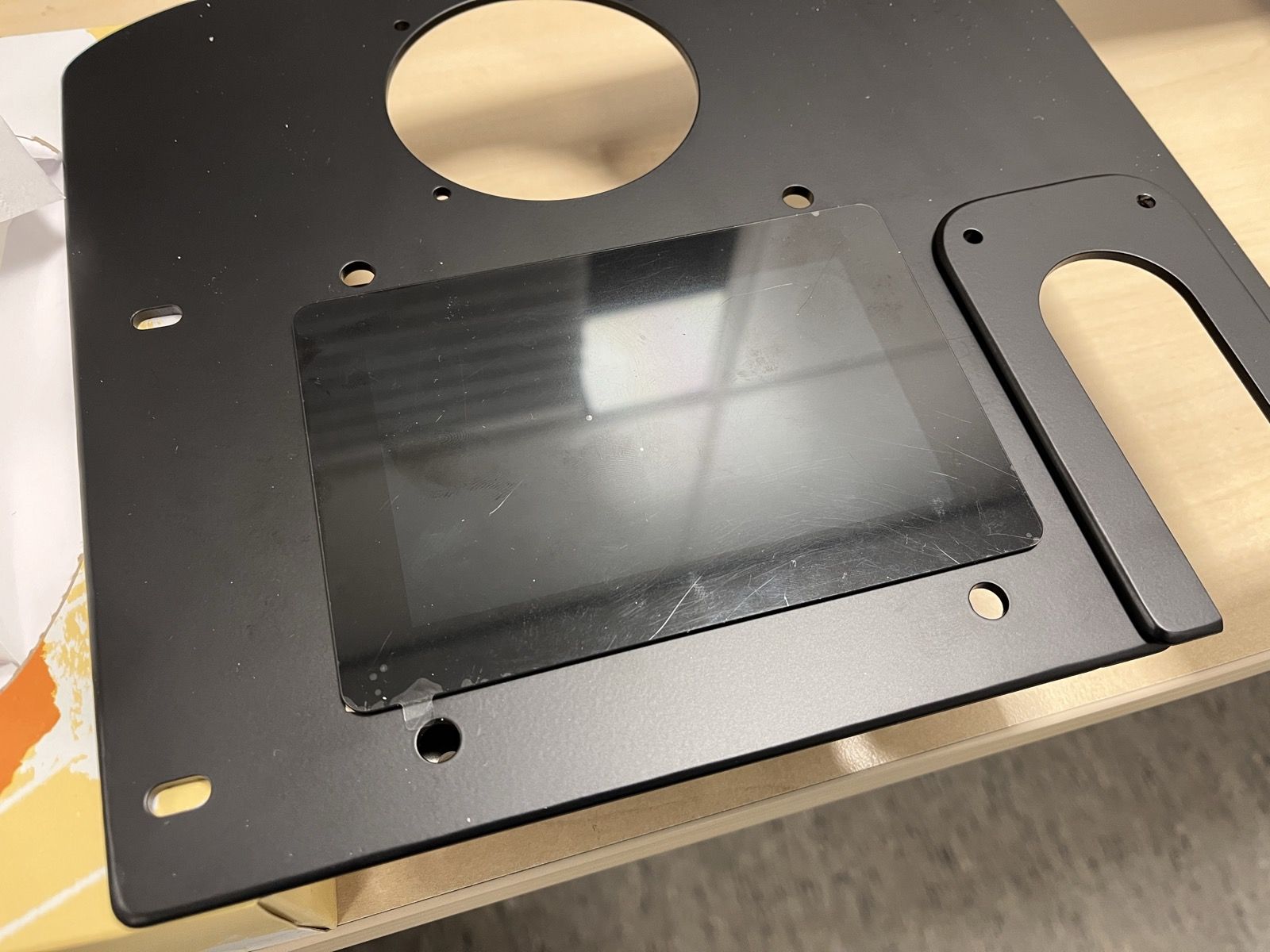The redesigned black panel with a display fitted, lying on a desk