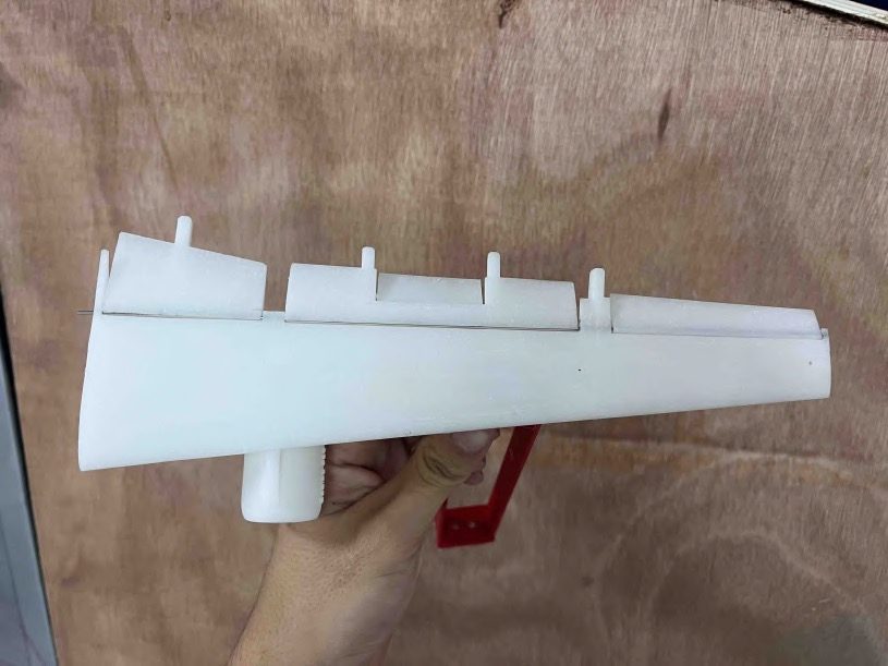White 3D-printed Boeing 737-NG airfoil section held in a hand