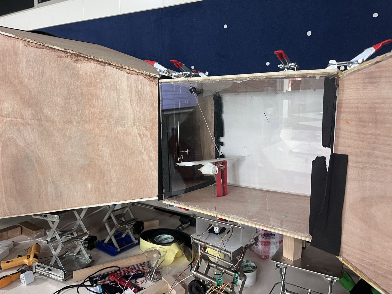 Transparent test section opened up, with the white airfoil mounted on its support inside